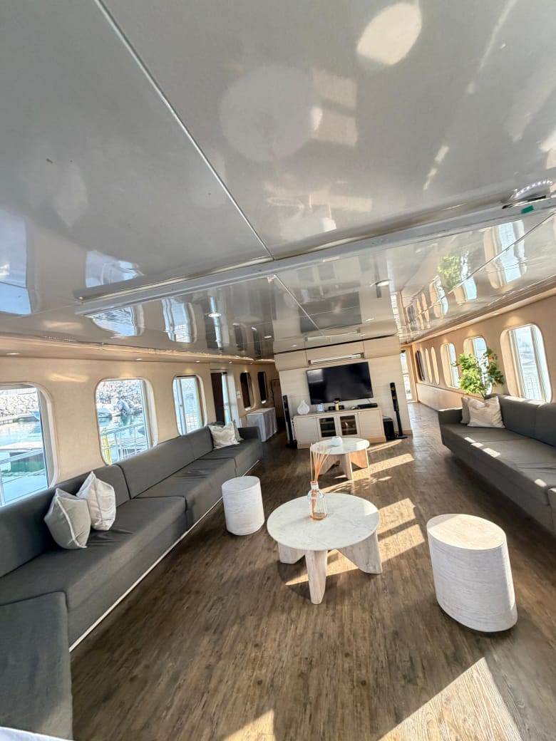 Lounge with sofas on both sides leading to a TV and sound system