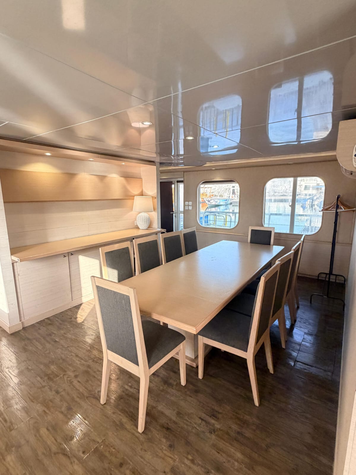 Dining table set for a group with windows looking out over the water